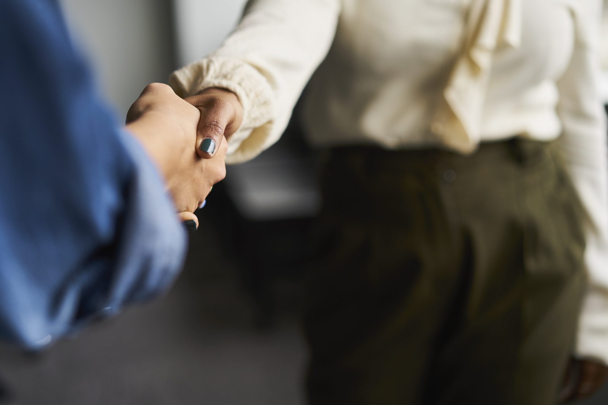 Businesswomen shaking hands in conference room