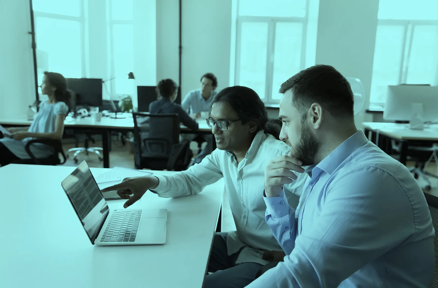 Coworkers looking at a screen
